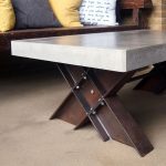 "Polished concrete coffee table with I-beam trestle legs"