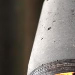 "Industrial concrete and steel exposed bulb pendant light close-up of steel rings from below" "by Brutal Design"