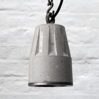 "Concrete pendant lamp with heavy duty hanging chain and steel edging ring" "By Brutal Design"